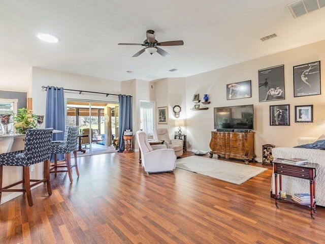 living room with hardwood / wood-style floors and ceiling fan