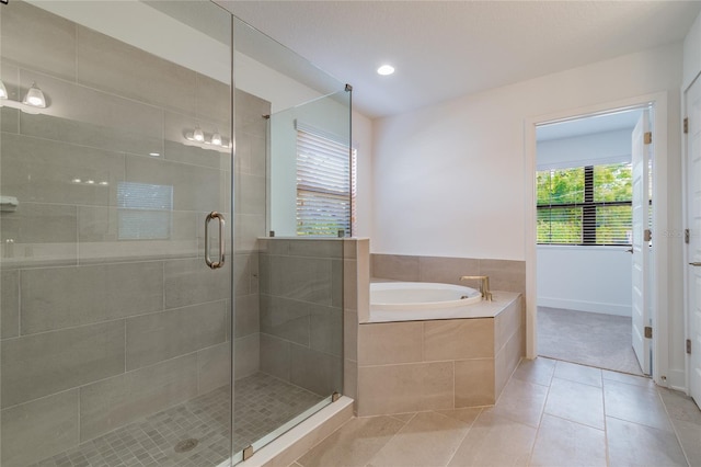 bathroom with shower with separate bathtub and tile patterned floors