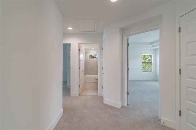 corridor featuring baseboards, light carpet, and recessed lighting
