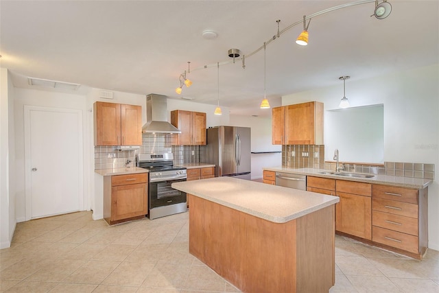 kitchen with sink, hanging light fixtures, wall chimney exhaust hood, decorative backsplash, and appliances with stainless steel finishes