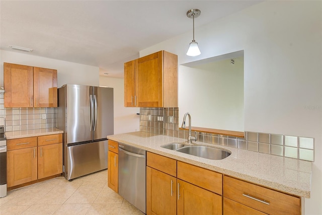 kitchen with backsplash, stainless steel appliances, hanging light fixtures, and sink