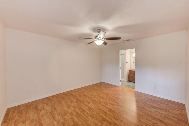 unfurnished room featuring ceiling fan, light hardwood / wood-style floors, and a textured ceiling