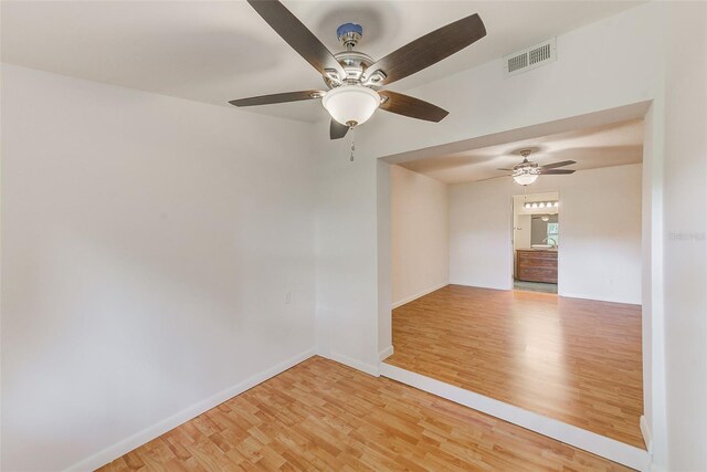 empty room featuring hardwood / wood-style floors and ceiling fan