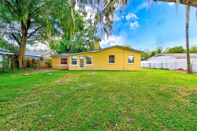 back of property featuring a yard