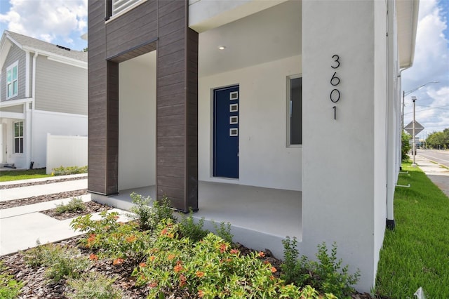 210 E Janette Ave, Tampa, FL 33603 - doorway to property featuring stucco siding