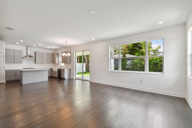 210 E Janette Ave, Tampa, FL 33603 - unfurnished living room with a chandelier, dark wood-style flooring, visible vents, and a sink