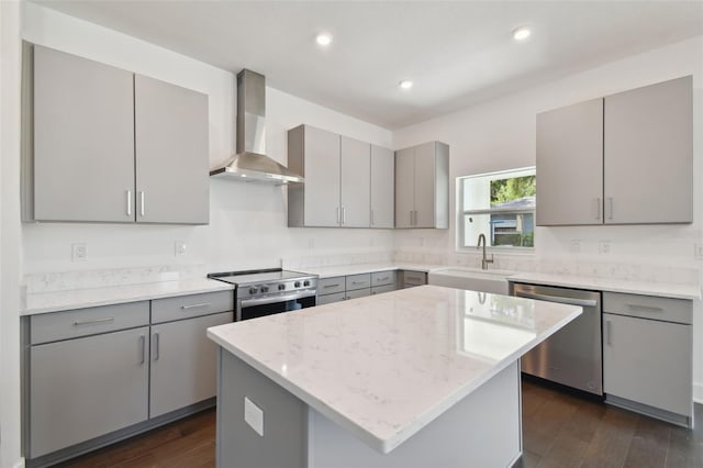 210 E Janette Ave, Tampa, FL 33603 - kitchen with gray cabinetry, dark wood-style flooring, a sink, appliances with stainless steel finishes, and wall chimney range hood
