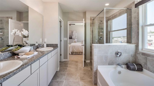 bathroom featuring separate shower and tub, dual bowl vanity, and tile patterned floors