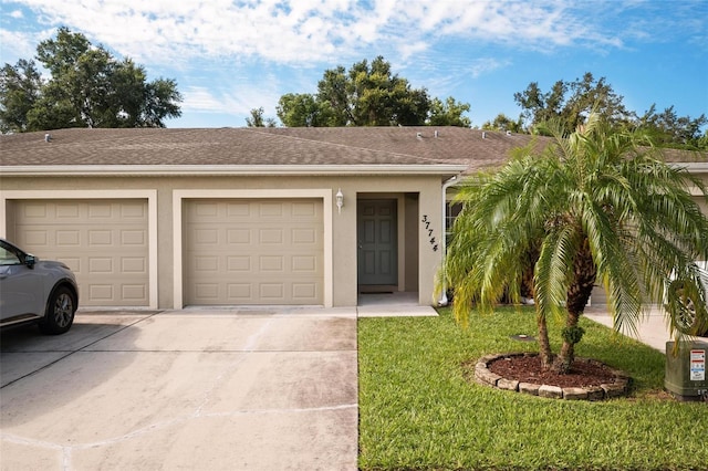 single story home with a front lawn and a garage