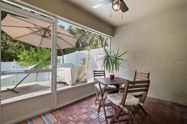 sunroom featuring ceiling fan