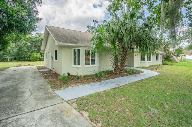 view of side of home featuring a lawn