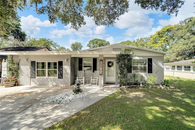 ranch-style home with covered porch and a front lawn