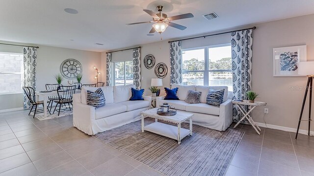 tiled living room featuring ceiling fan