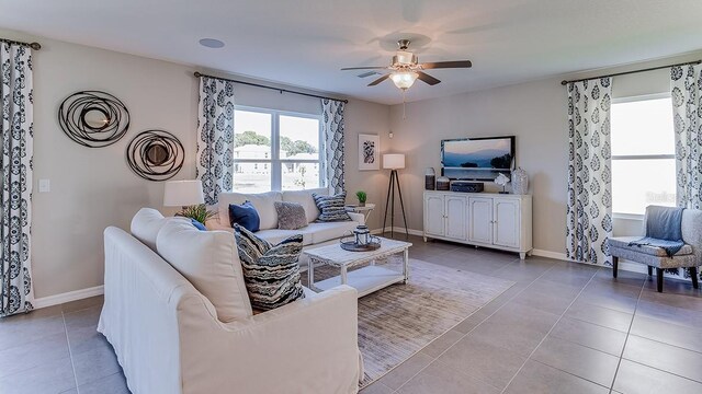 living room featuring ceiling fan and light tile patterned flooring