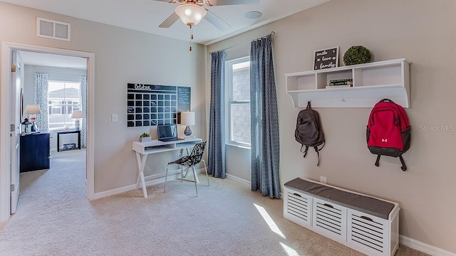 mudroom with ceiling fan and light carpet