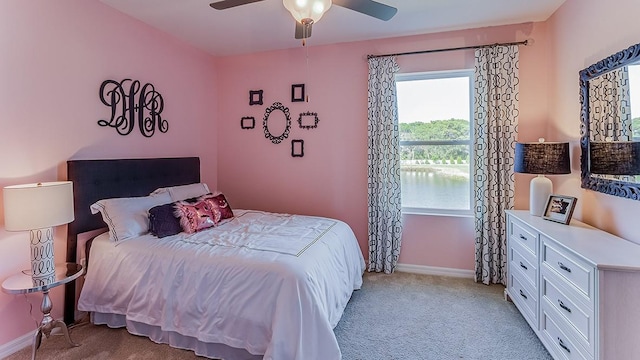 bedroom featuring light colored carpet and ceiling fan