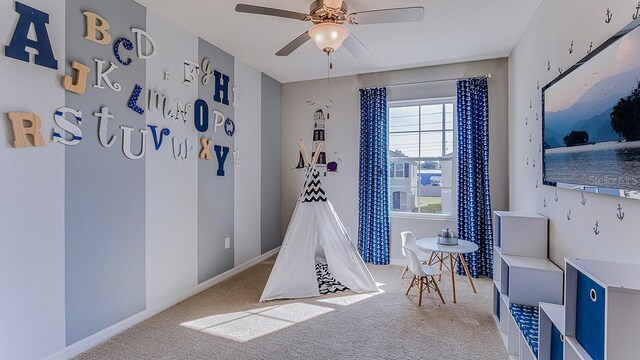 recreation room with carpet and ceiling fan