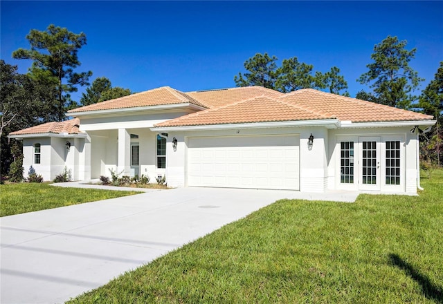 mediterranean / spanish-style home with a tiled roof, an attached garage, french doors, a front yard, and stucco siding