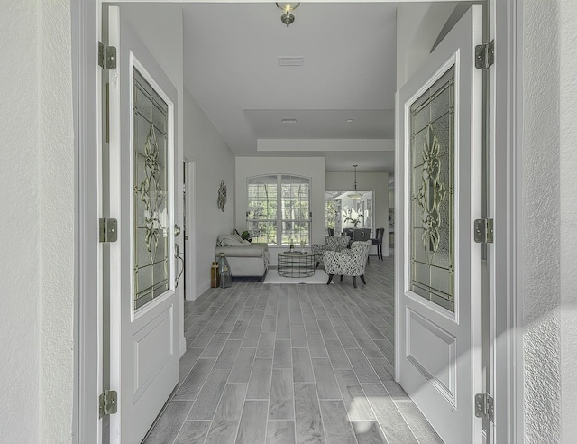 entrance foyer with wood tiled floor and visible vents