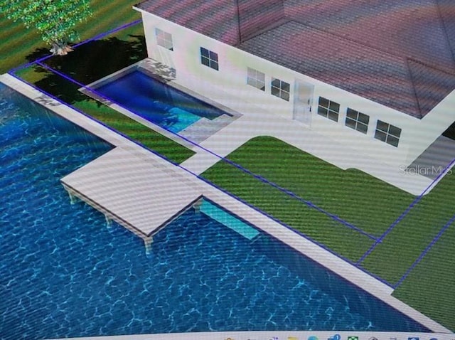 exterior space with an infinity pool, a patio area, and a lawn