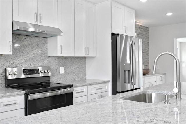 kitchen with white cabinetry, sink, stainless steel appliances, tasteful backsplash, and light stone counters