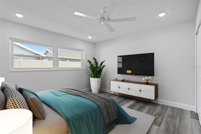 bedroom with dark hardwood / wood-style floors and ceiling fan