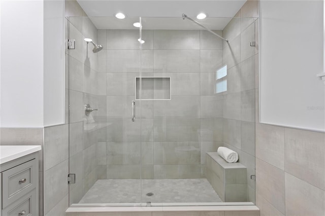 bathroom with vanity and a shower with shower door