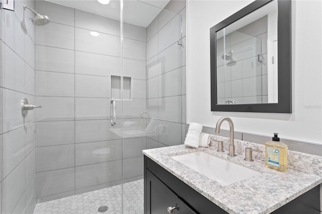 bathroom featuring vanity and an enclosed shower