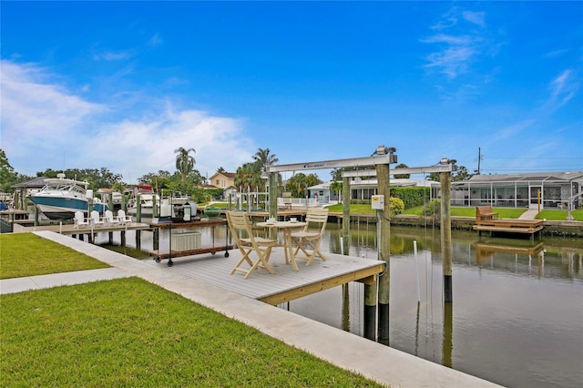 dock area featuring a lawn and a water view