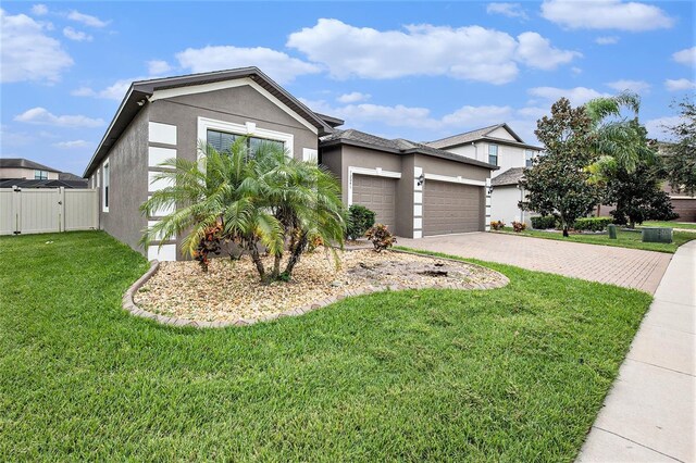 view of front of property featuring a garage and a front lawn