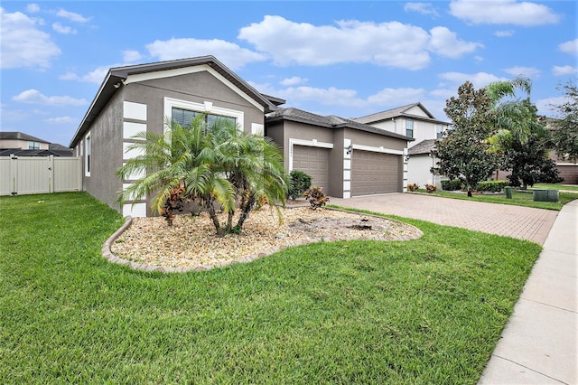 view of front facade featuring decorative driveway, stucco siding, a gate, a garage, and a front lawn