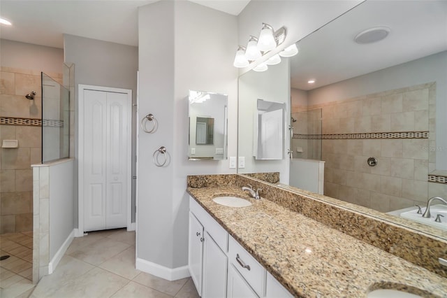 full bathroom featuring tile patterned flooring, double vanity, a sink, and walk in shower