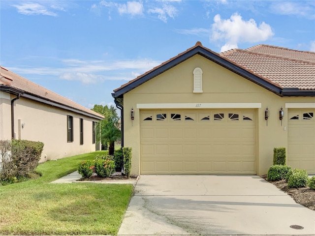 exterior space featuring driveway, a tiled roof, an attached garage, and stucco siding