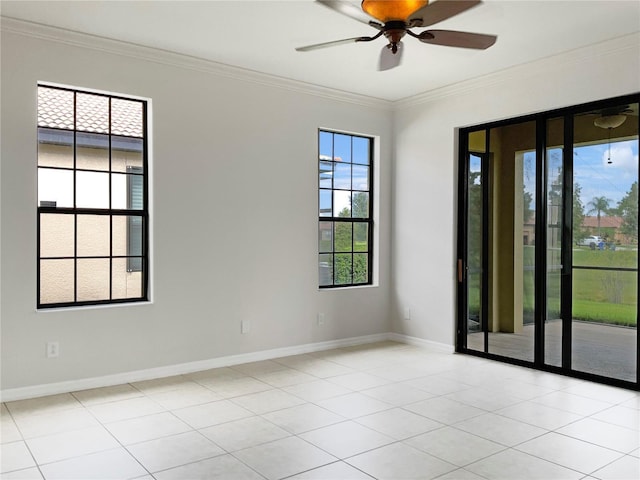 spare room with ceiling fan, baseboards, crown molding, and light tile patterned flooring