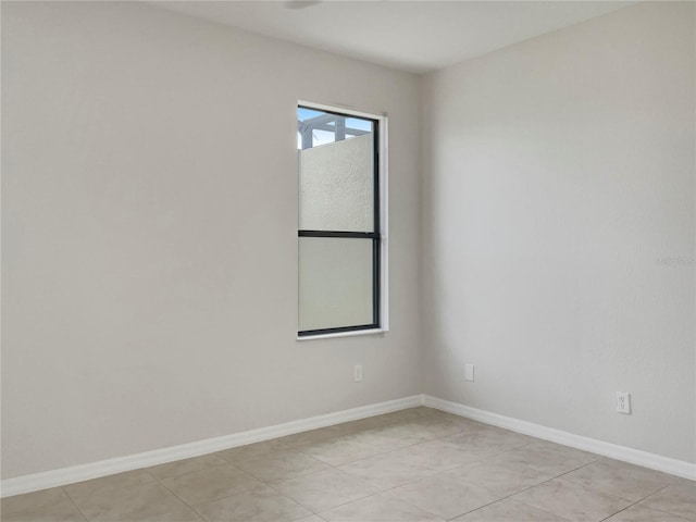 unfurnished room featuring baseboards