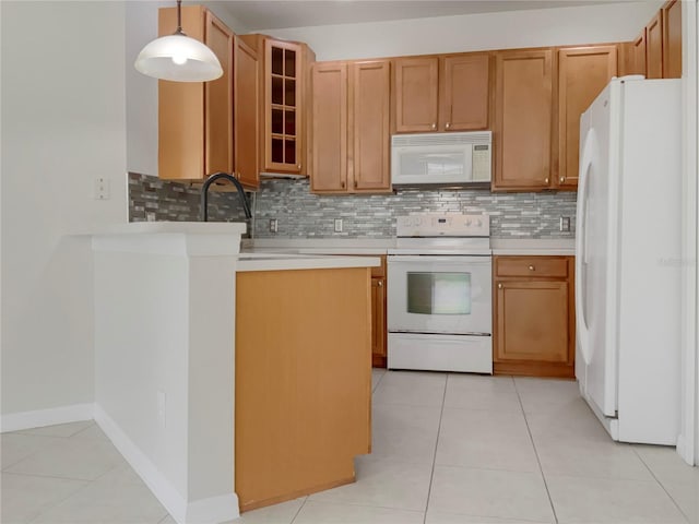 kitchen featuring white appliances, light tile patterned floors, glass insert cabinets, light countertops, and pendant lighting