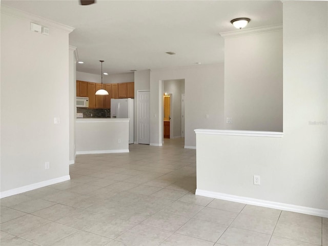 empty room featuring light tile patterned floors, ornamental molding, visible vents, and baseboards