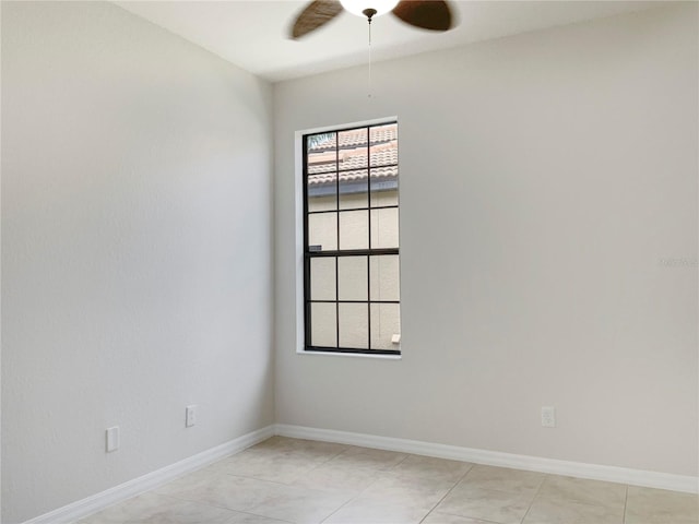 unfurnished room featuring ceiling fan and light tile patterned flooring