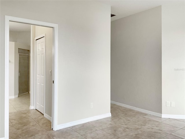 unfurnished room featuring light tile patterned flooring