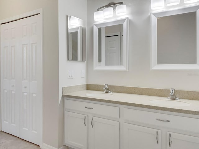 full bathroom with a sink, tile patterned flooring, double vanity, and a closet