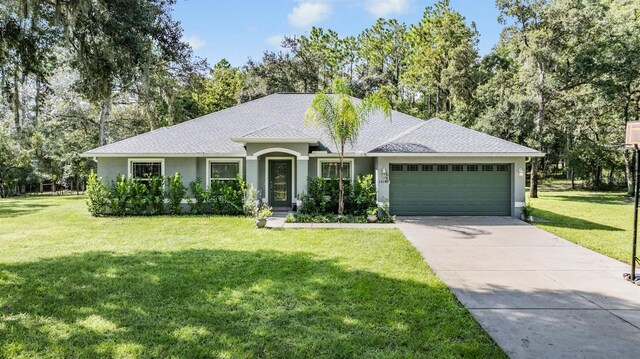 ranch-style home featuring a front lawn and a garage