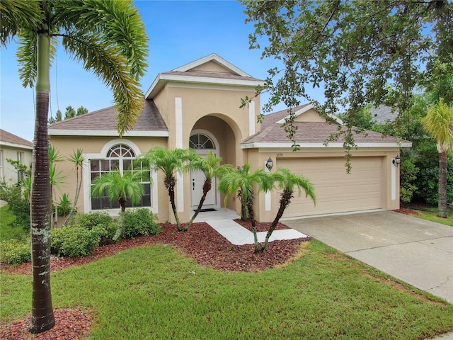 view of front of property featuring a garage and a front lawn