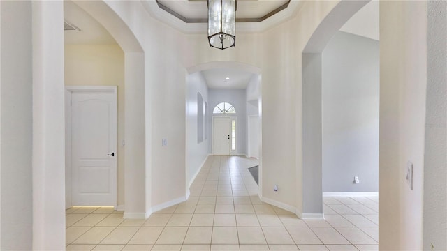 tiled foyer entrance featuring a raised ceiling