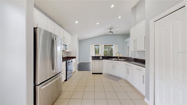 kitchen featuring white cabinetry, sink, ceiling fan, vaulted ceiling, and appliances with stainless steel finishes