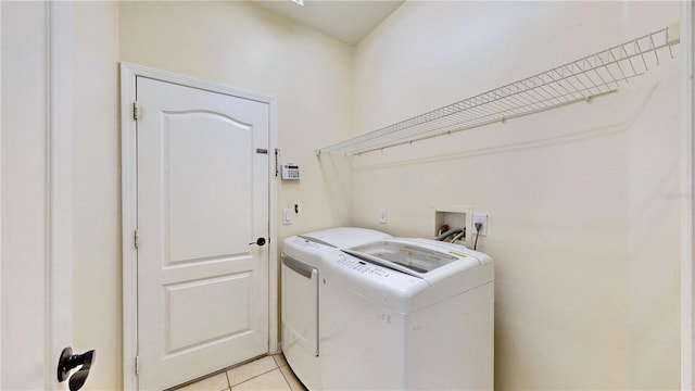 laundry room with separate washer and dryer and light tile patterned floors