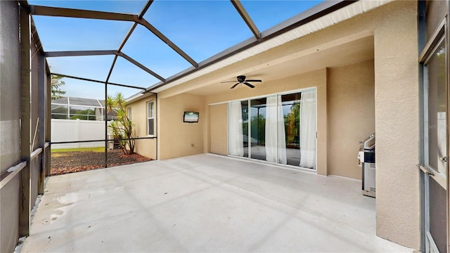 unfurnished sunroom with ceiling fan and a wealth of natural light