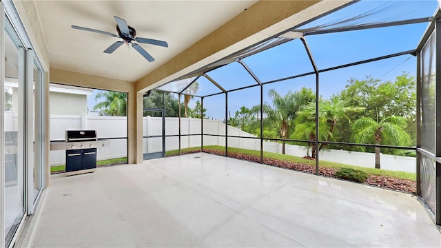 unfurnished sunroom featuring ceiling fan