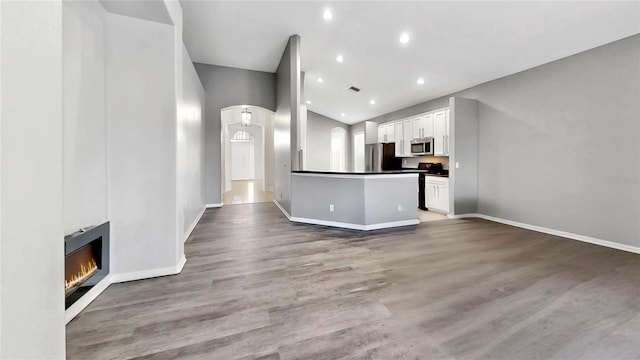 unfurnished living room featuring hardwood / wood-style floors