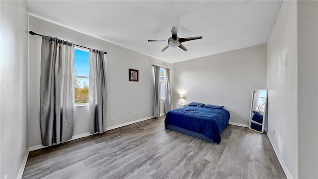 bedroom with hardwood / wood-style flooring and ceiling fan