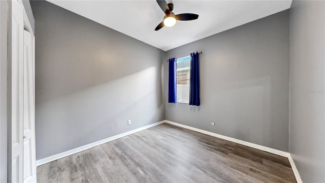 unfurnished room with ceiling fan and hardwood / wood-style flooring